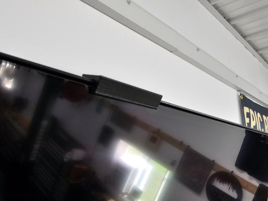 Retention clip installed on a Samsung Crystal UHD TV frame holding the screen in place