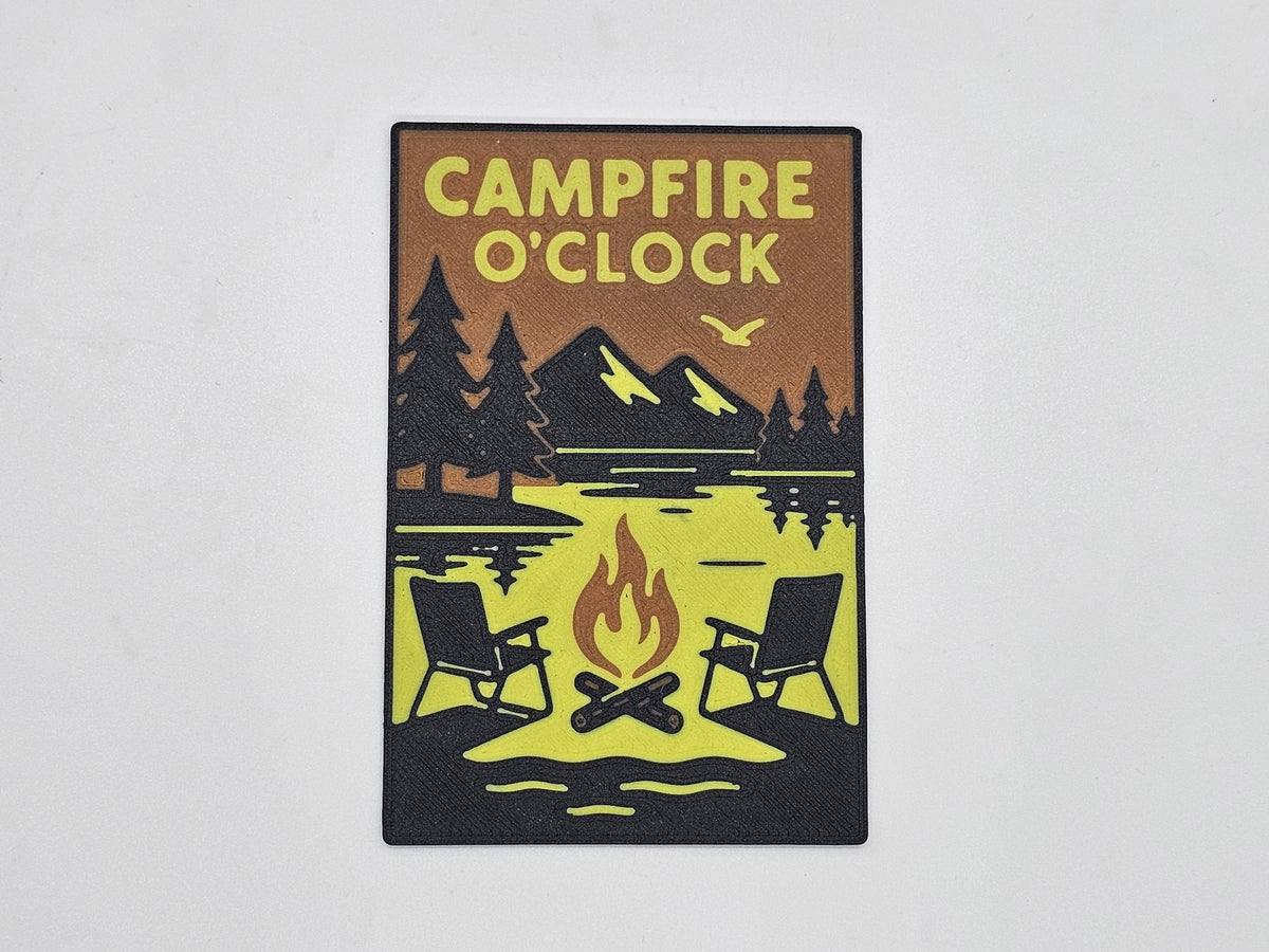 Black, tan, and yellow Campfire O'Clock camping magnet