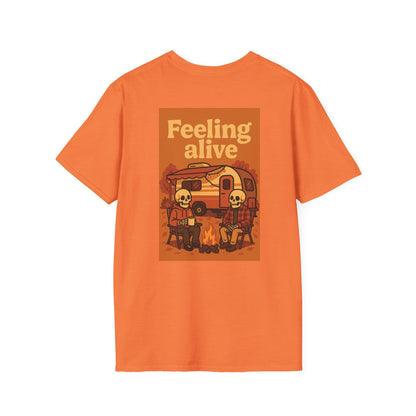 Orange t-shirt with a graphic design of two skeletons by a campfire and text 'Feeling alive' on a white background.