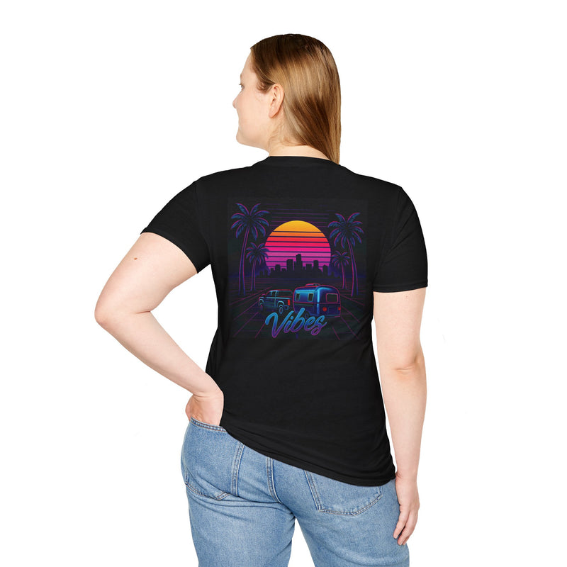 Vibes retro sunset RV t-shirt with a truck and travel trailer rolling toward a neon city skyline framed by palm trees