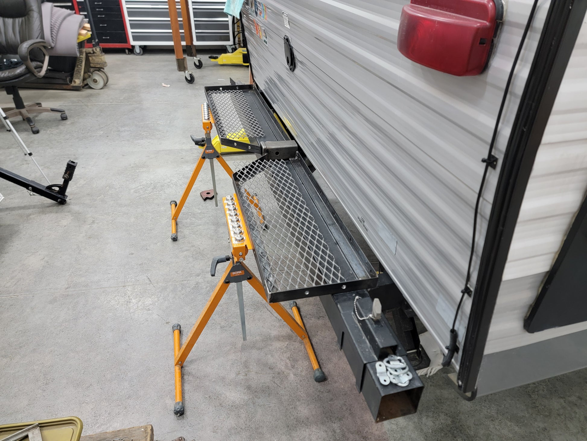 Custom built RV rear bumper rack with receiver hitch bike mount and generator platform.