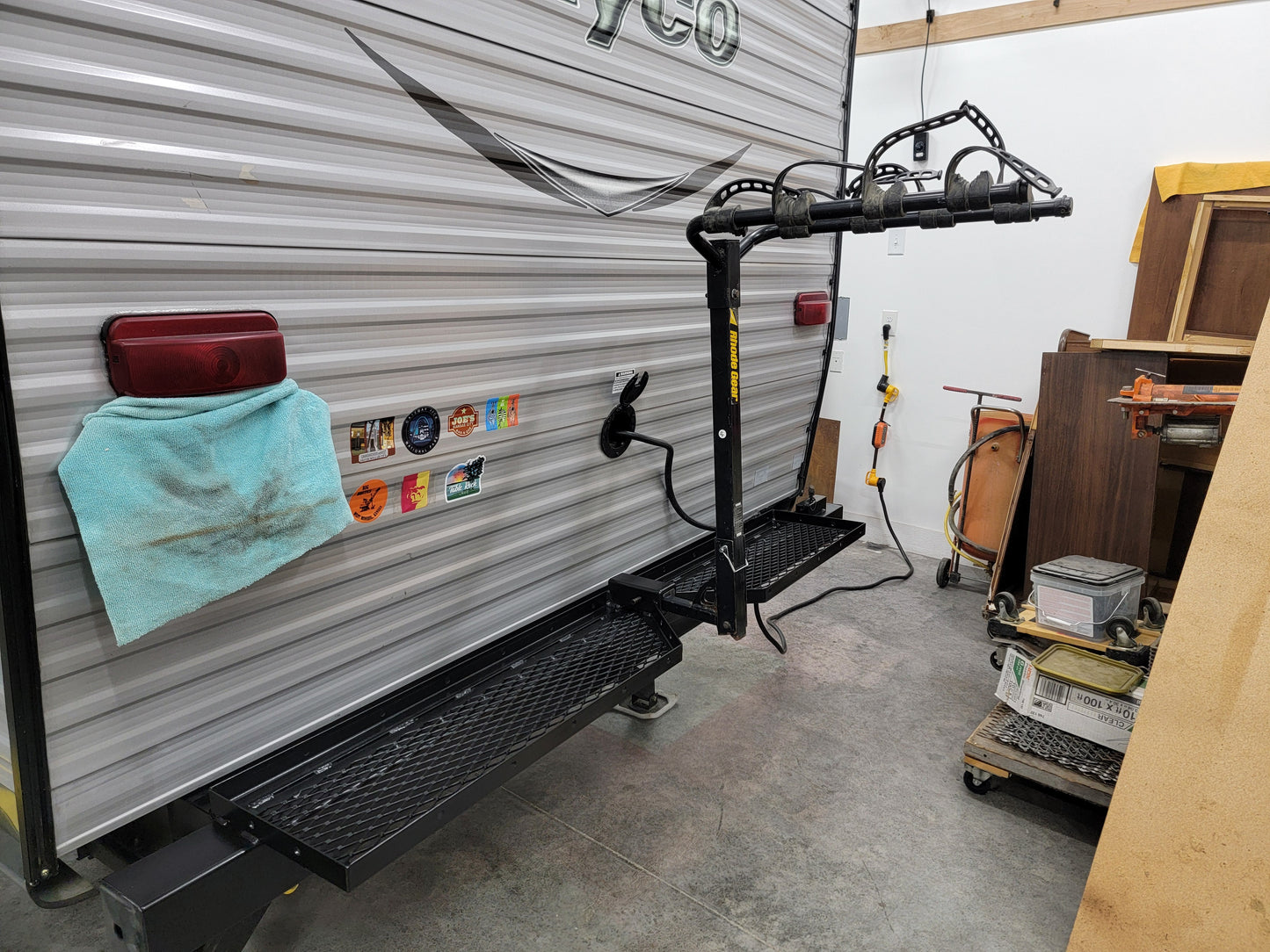 RV with a bike rack attached in a garage setting