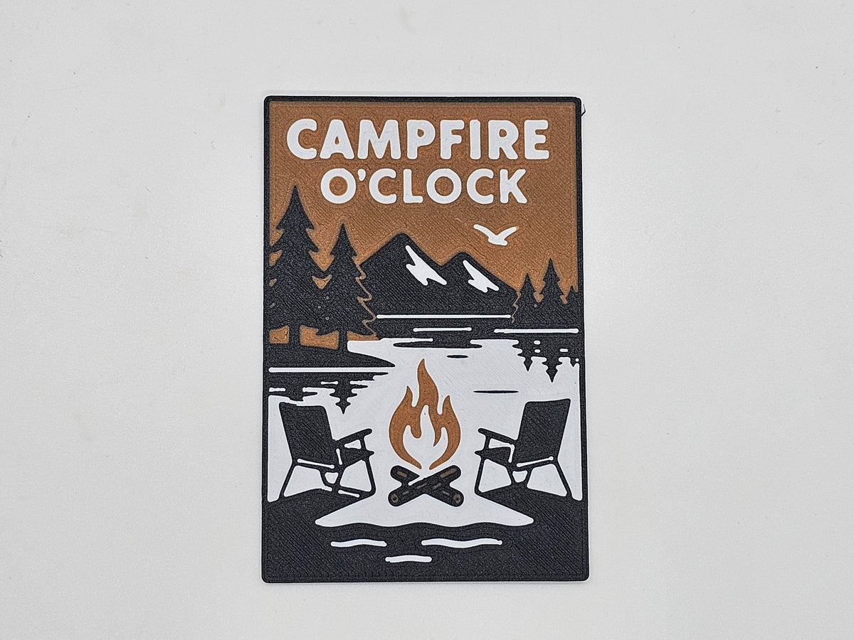 Black, tan, and white Campfire O'Clock camping magnet