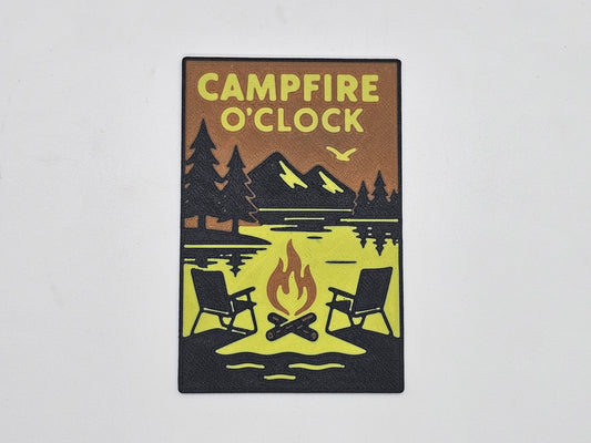 Black, tan, and yellow Campfire O'Clock camping magnet