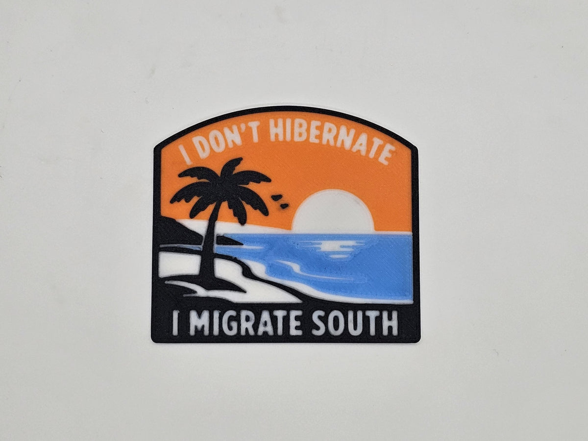 Orange, blue, and black I Don't Hibernate, I Migrate South snowbird RV magnet