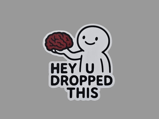 White, black, and red Hey You Dropped This brain magnet with smiling figure