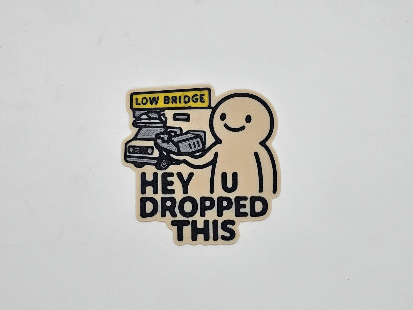 Tan and black Hey You Dropped This low bridge RV magnet with flattened camper