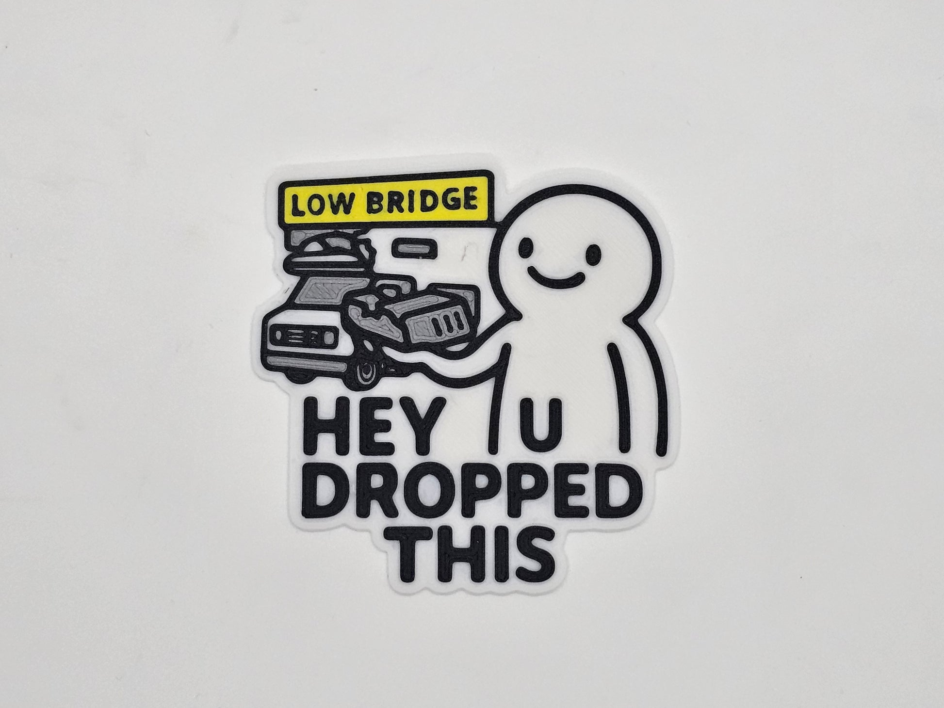 White and black Hey You Dropped This low bridge RV magnet with flattened camper