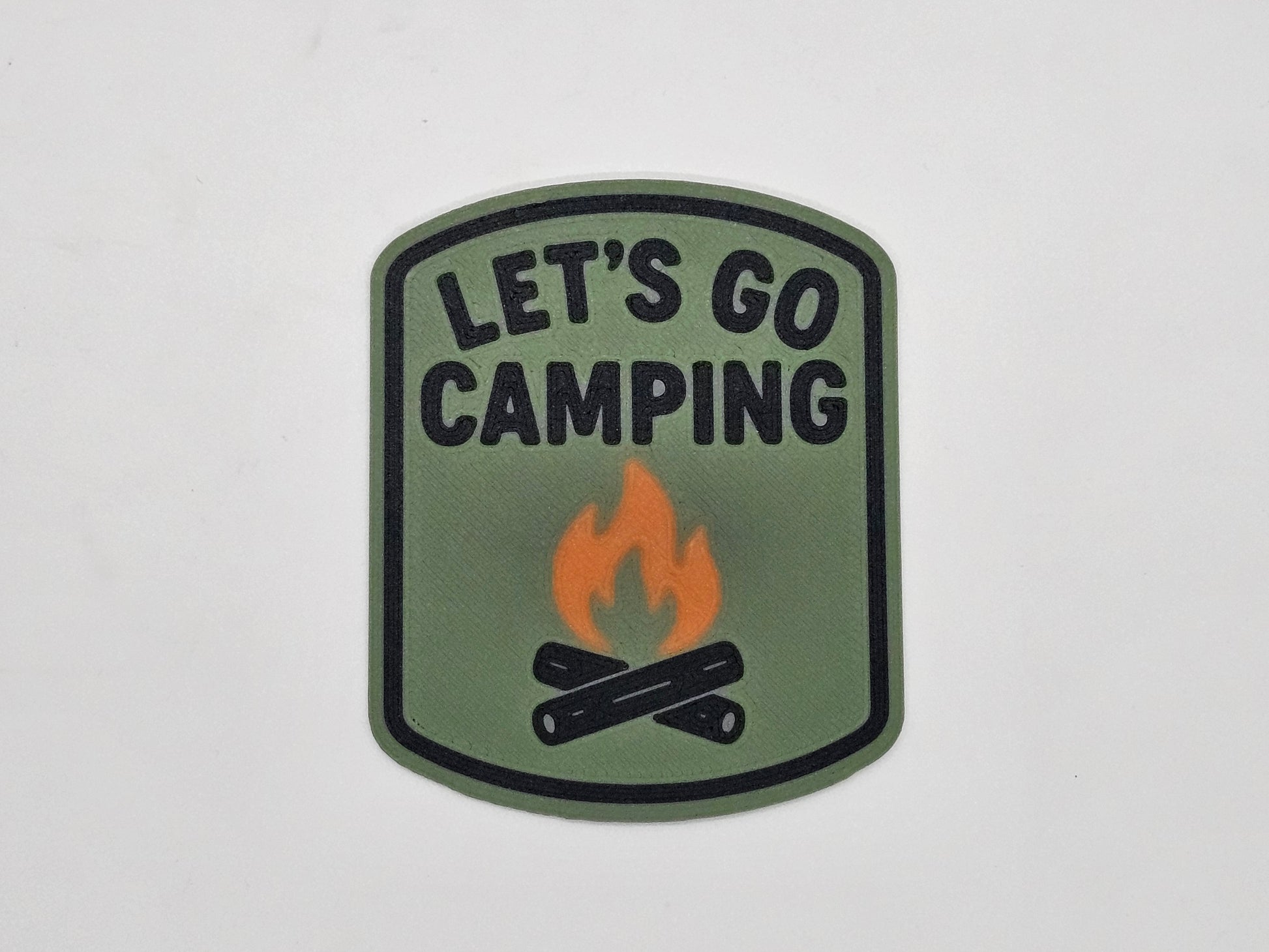 Olive, black, and orange Let's Go Camping campfire RV magnet