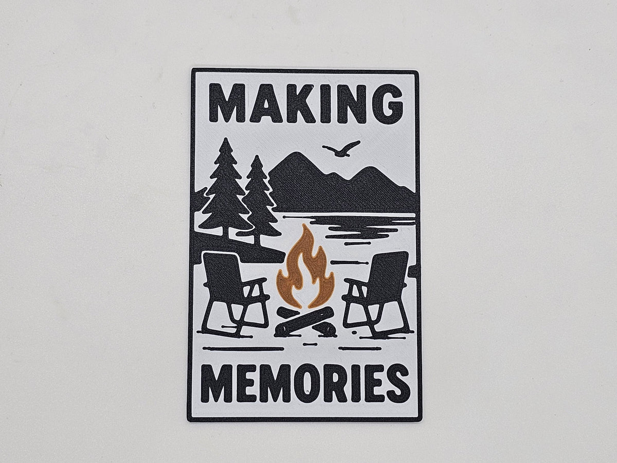 White, black, and brown Making Memories campfire camping magnet