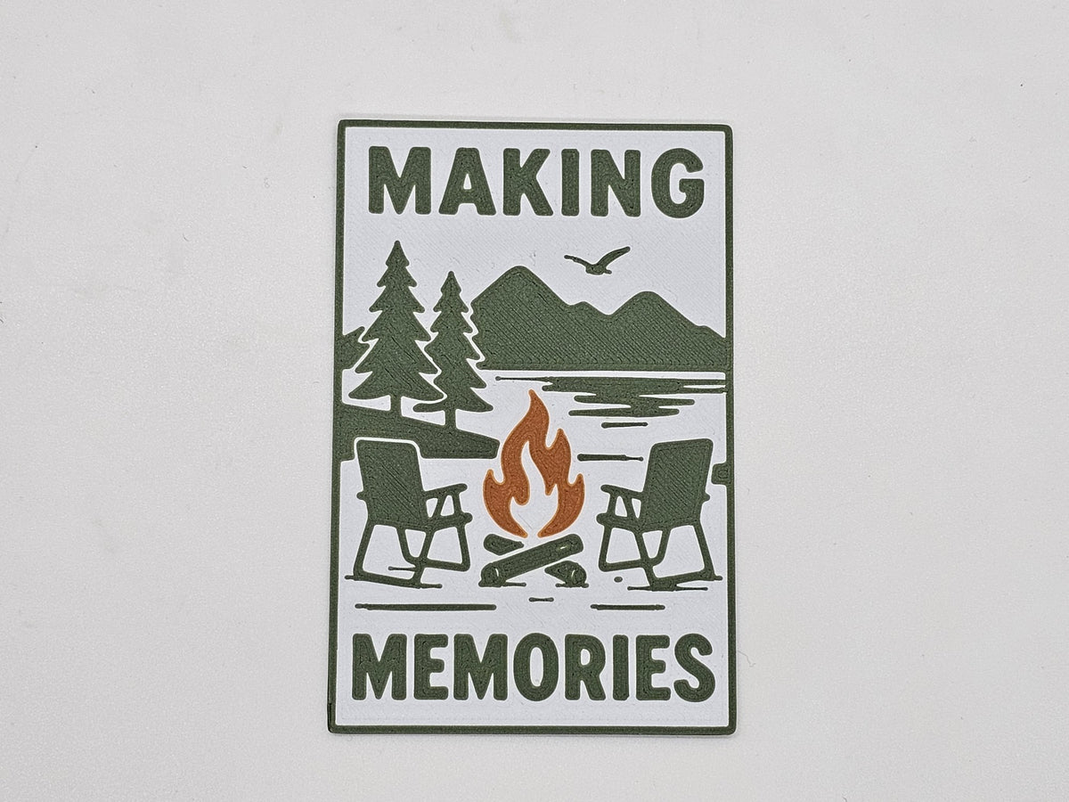 White, green, and brown Making Memories campfire camping magnet