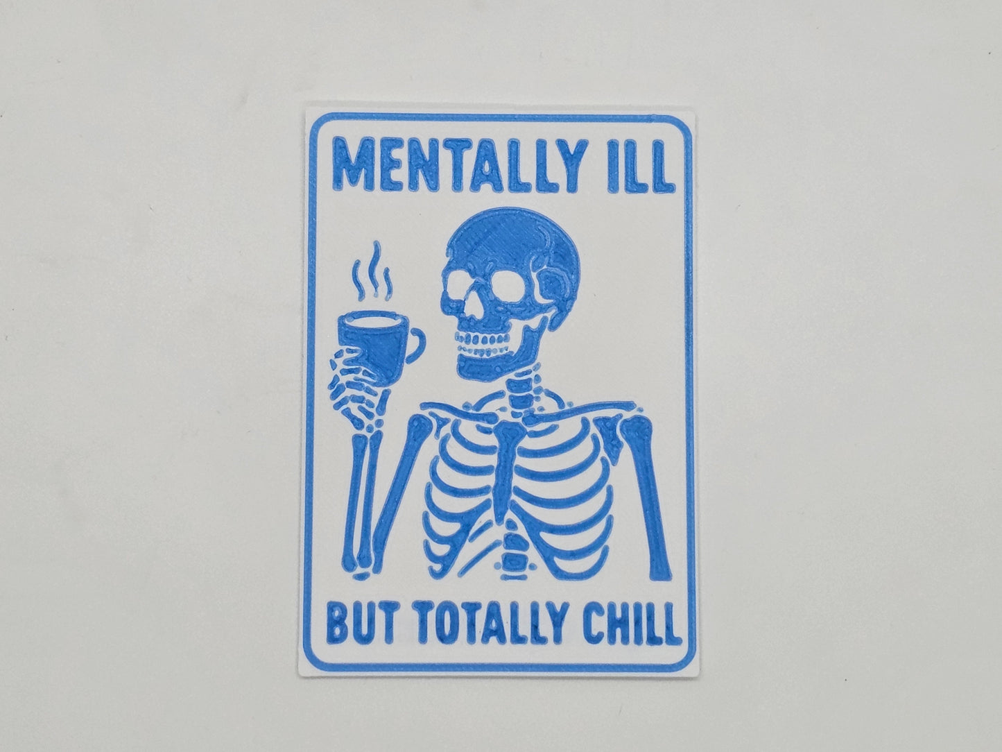White and light blue Mentally Ill but Totally Chill skeleton coffee magnet