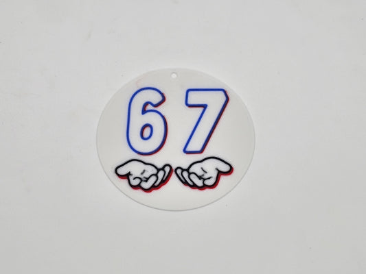 Round white, blue, and red 67 hand gesture meme magnet