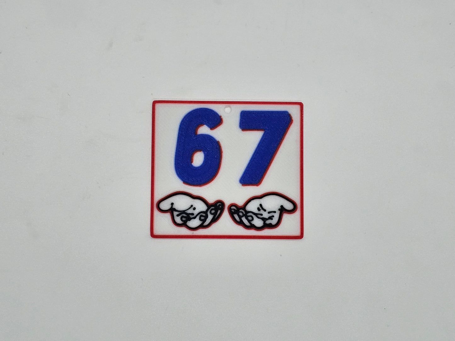 Square white, blue, and red 67 hand gesture meme magnet