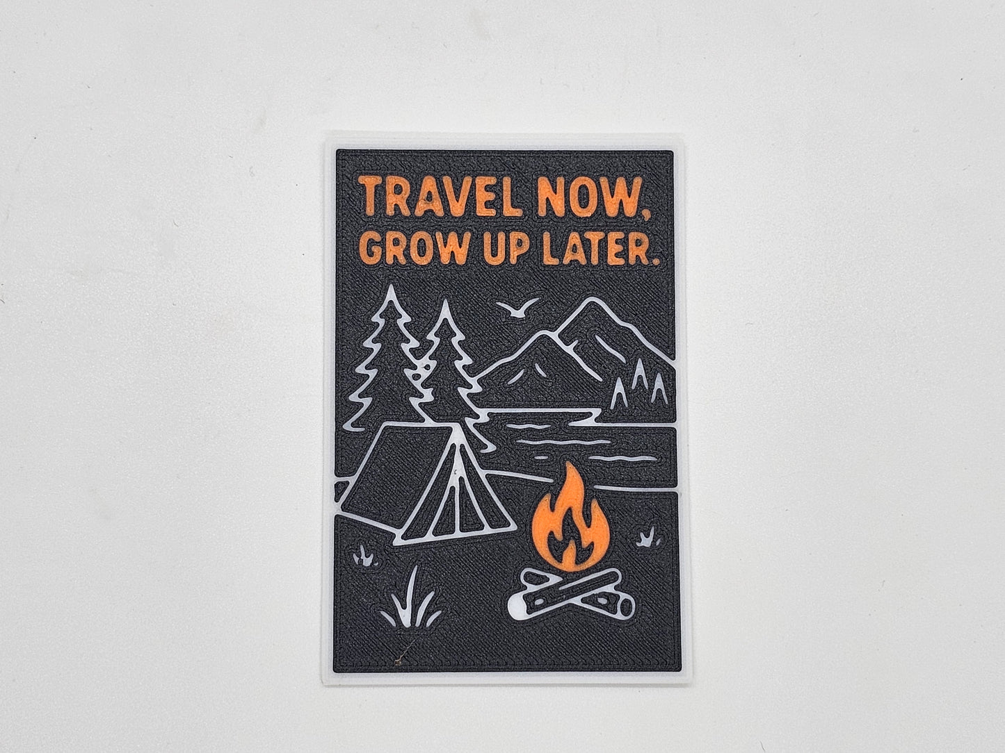 Black and orange Travel Now Grow Up Later camping magnet