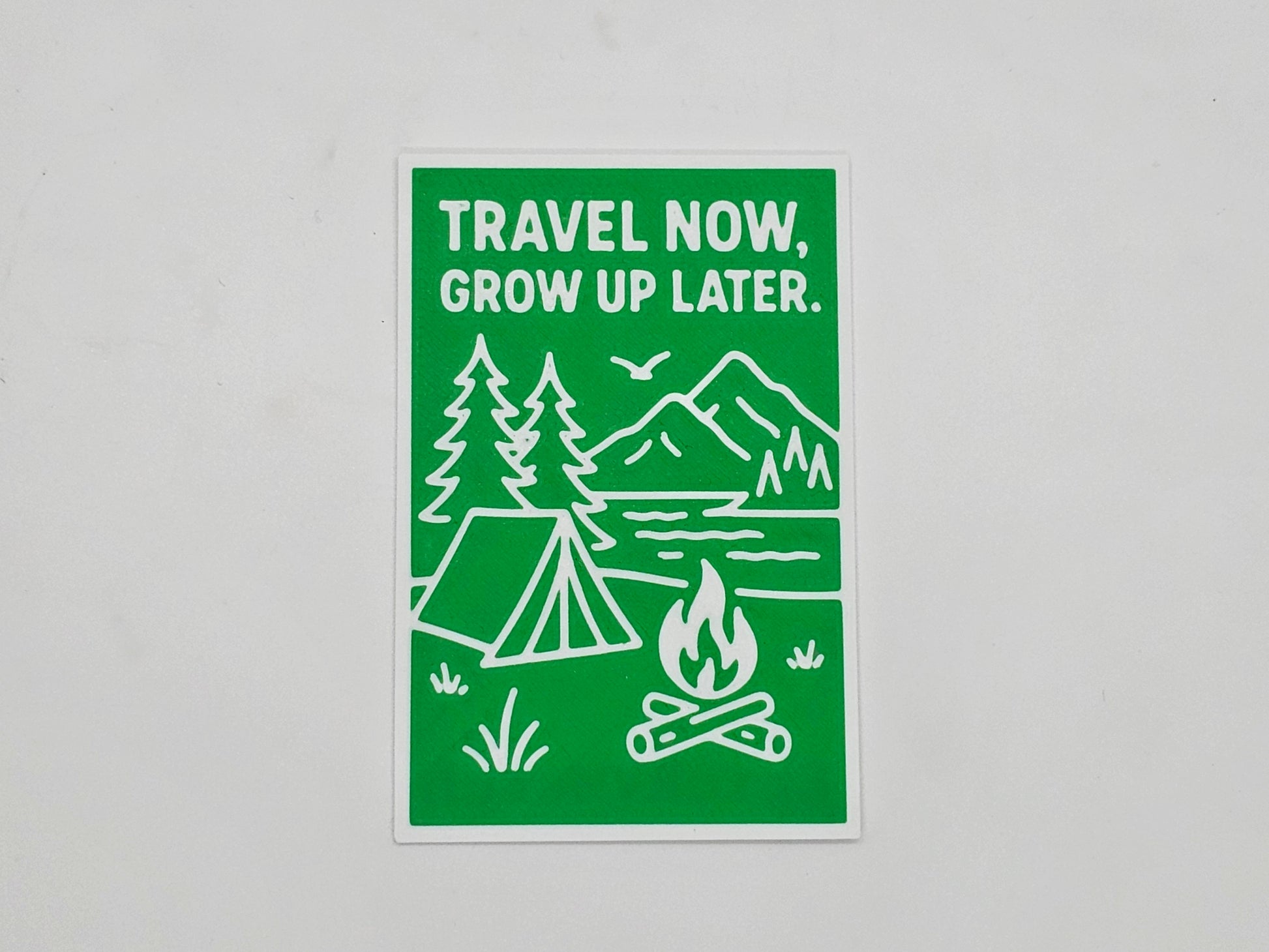Green and white Travel Now Grow Up Later camping magnet
